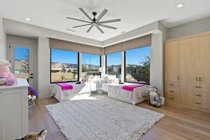 Bedroom featuring light wood finished floors, ceiling fan, and recessed lighting