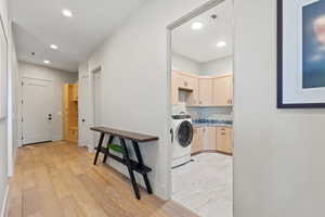Laundry area with cabinet space, recessed lighting, and light wood-type flooring