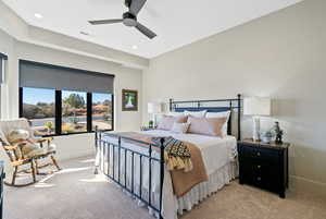 Carpeted bedroom with ceiling fan and recessed lighting