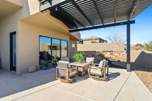 View of patio with a pergola and an outdoor fire pit