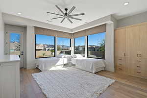 Bedroom featuring light wood-type flooring, ceiling fan, and recessed lighting