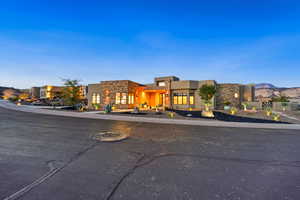 View of front facade featuring stone siding, stucco siding, and a residential view