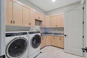 Laundry room with cabinet space and independent washer and dryer