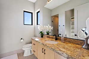 Bathroom featuring a shower stall and vanity