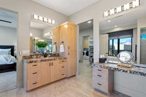 Ensuite bathroom featuring vanity and separate washer and dryer