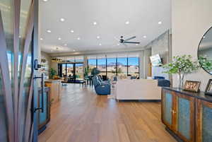Living area with light wood-style floors, recessed lighting, and ceiling fan