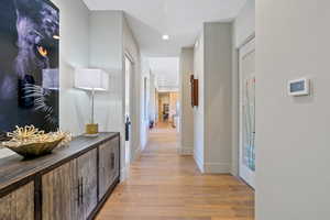 Hall featuring light wood-style floors and recessed lighting