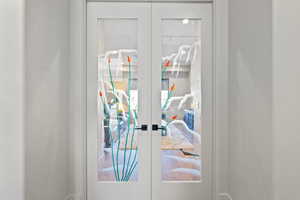 Detailed view of french doors and baseboards