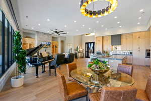 Dining space with light wood-type flooring, recessed lighting, and a ceiling fan