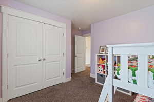 Bedroom featuring carpet and a closet