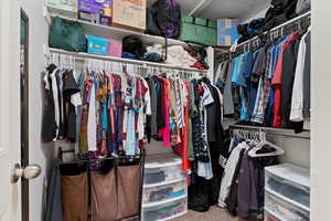 Walk in closet featuring carpet