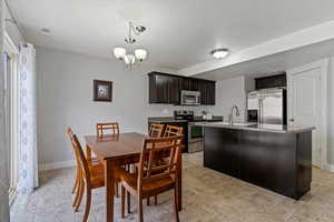 Dining room with hanging lights and baseboards