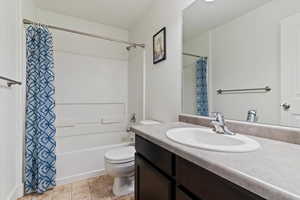 Full bathroom featuring vanity and shower / bathtub combination with curtain