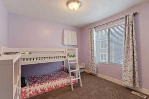Bedroom featuring baseboards and carpet