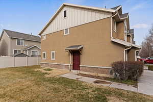 View of home's exterior featuring board and batten siding and brick siding