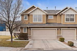 Craftsman inspired home with board and batten siding, a shingled roof, concrete driveway, an attached garage, and stucco siding