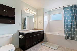 Full bathroom featuring vanity and shower / bath combination with curtain