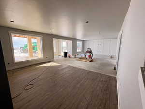 Recreation room featuring baseboards and wood finished floors