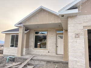 Doorway to property with covered porch