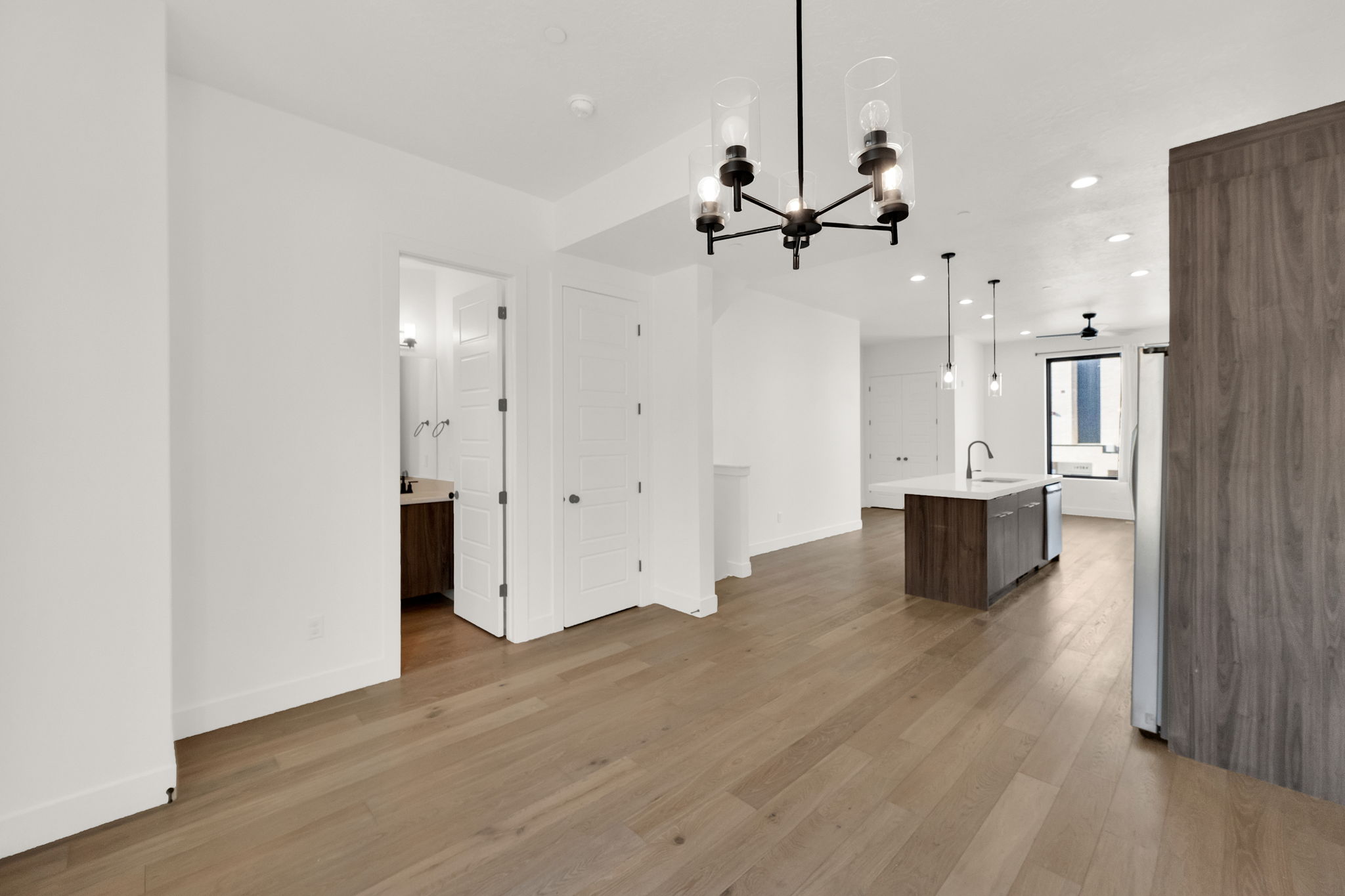 Unfurnished dining area featuring light wood-type flooring and suspended lighting