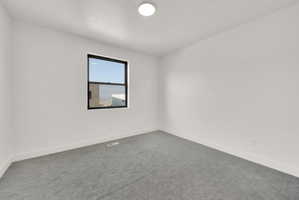 Unfurnished room with carpet and baseboards