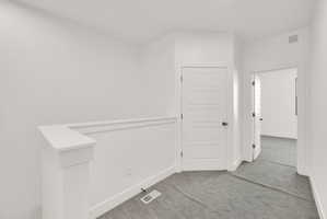 Empty room featuring carpet floors and baseboards