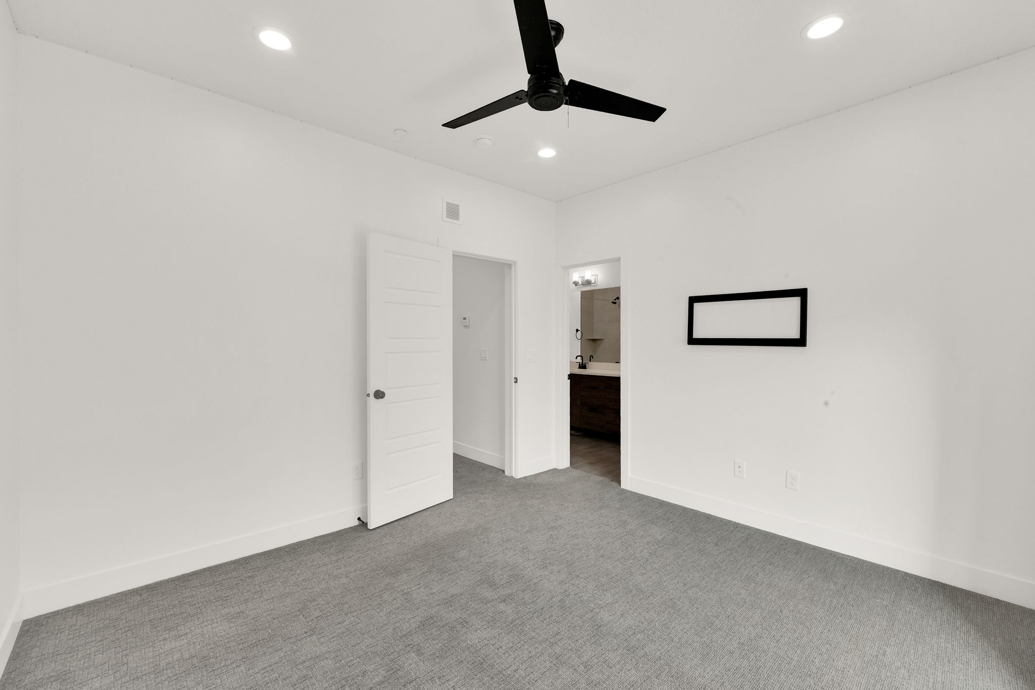 Unfurnished bedroom featuring ensuite bathroom, carpet, recessed lighting, and ceiling fan
