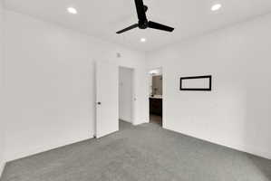 Unfurnished bedroom featuring ensuite bathroom, carpet, recessed lighting, and ceiling fan