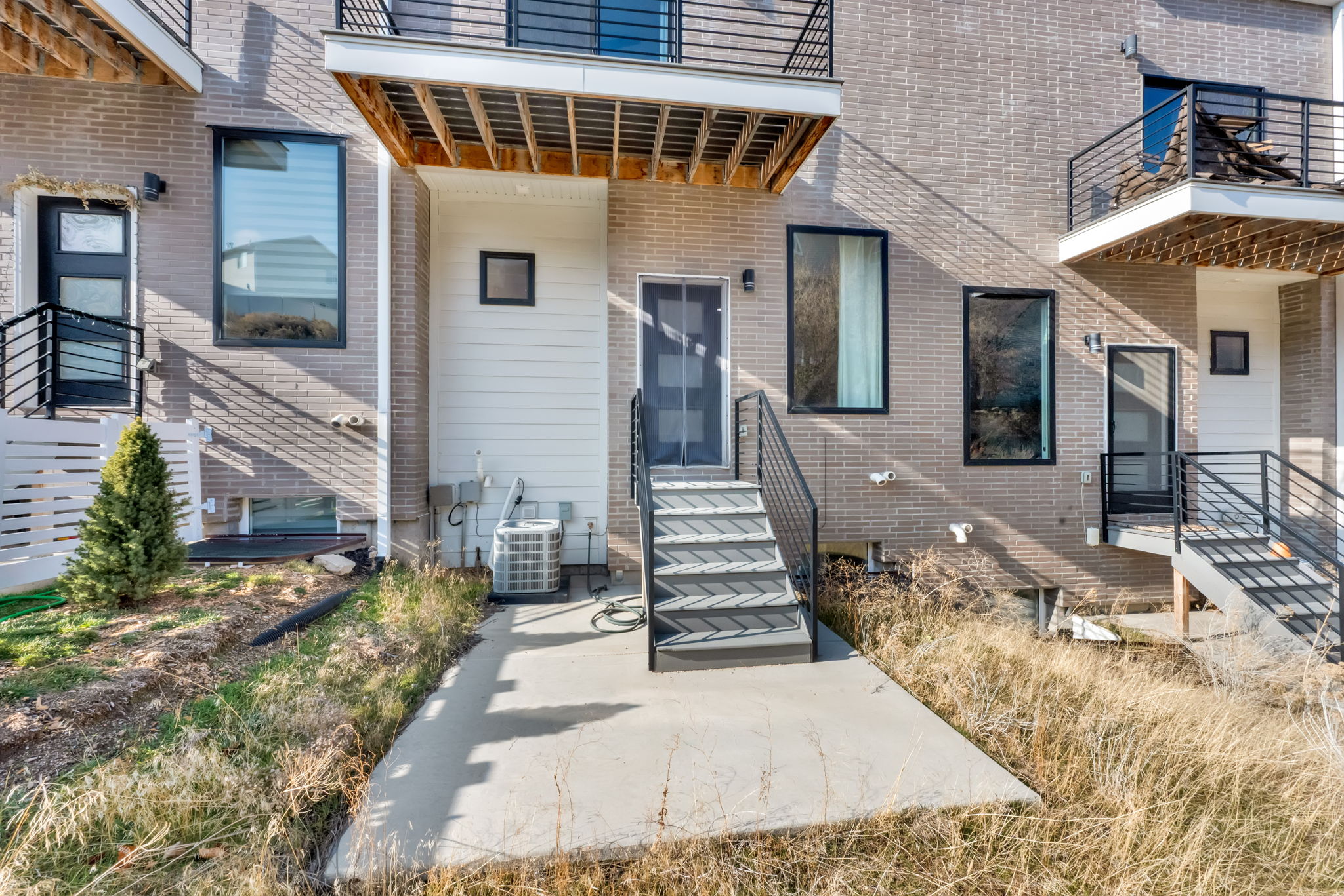 Entrance to property featuring a patio area and brick siding
