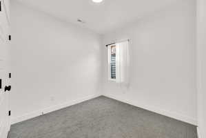 Unfurnished room featuring baseboards and carpet floors