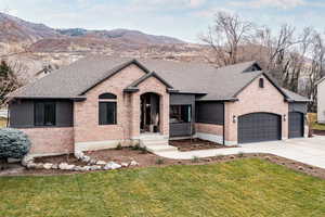 French country home with a front yard, brick siding, concrete driveway, and an attached garage