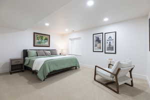Bedroom with light carpet and recessed lighting