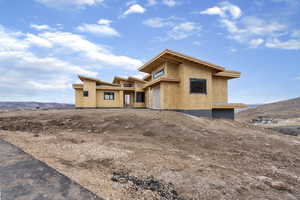 View of front of house featuring stucco siding and a mountain view