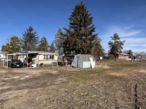 View of yard featuring a storage unit
