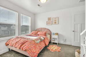 Carpeted bedroom featuring baseboards