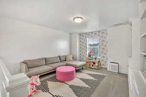Living area featuring carpet flooring and baseboards
