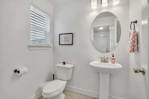 Bathroom with toilet and light tile patterned flooring