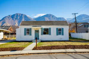 View of front of home featuring a mountain view and roof with shingles