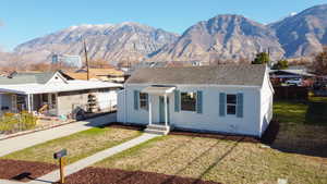 View of front of property featuring a mountain view and roof with shingles