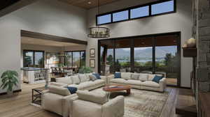 Living room with wood-type flooring, a chandelier, and a mountain view