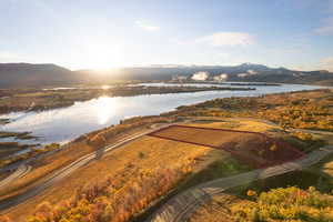 Aerial view of property's location featuring a water and mountain view and property parcel outlined