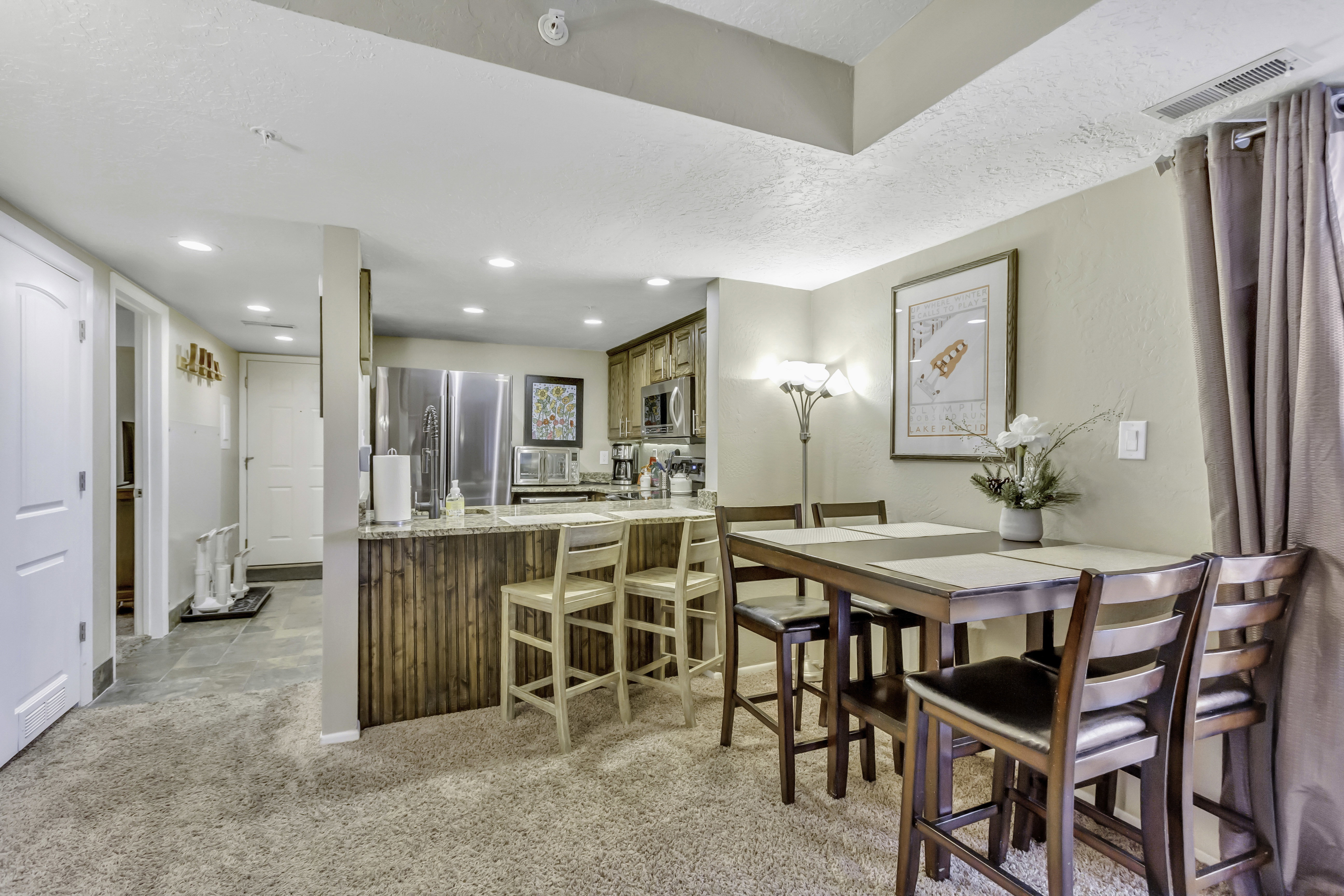Dining room featuring light colored carpet and recessed lighting