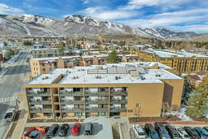 Bird's eye view of a mountain backdrop and apartment complex / building