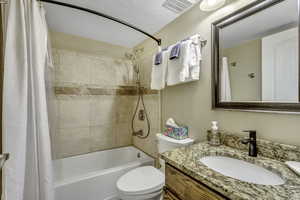 Bathroom featuring shower / bath combo with shower curtain and vanity