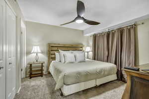 Bedroom with carpet flooring, ceiling fan, and a closet