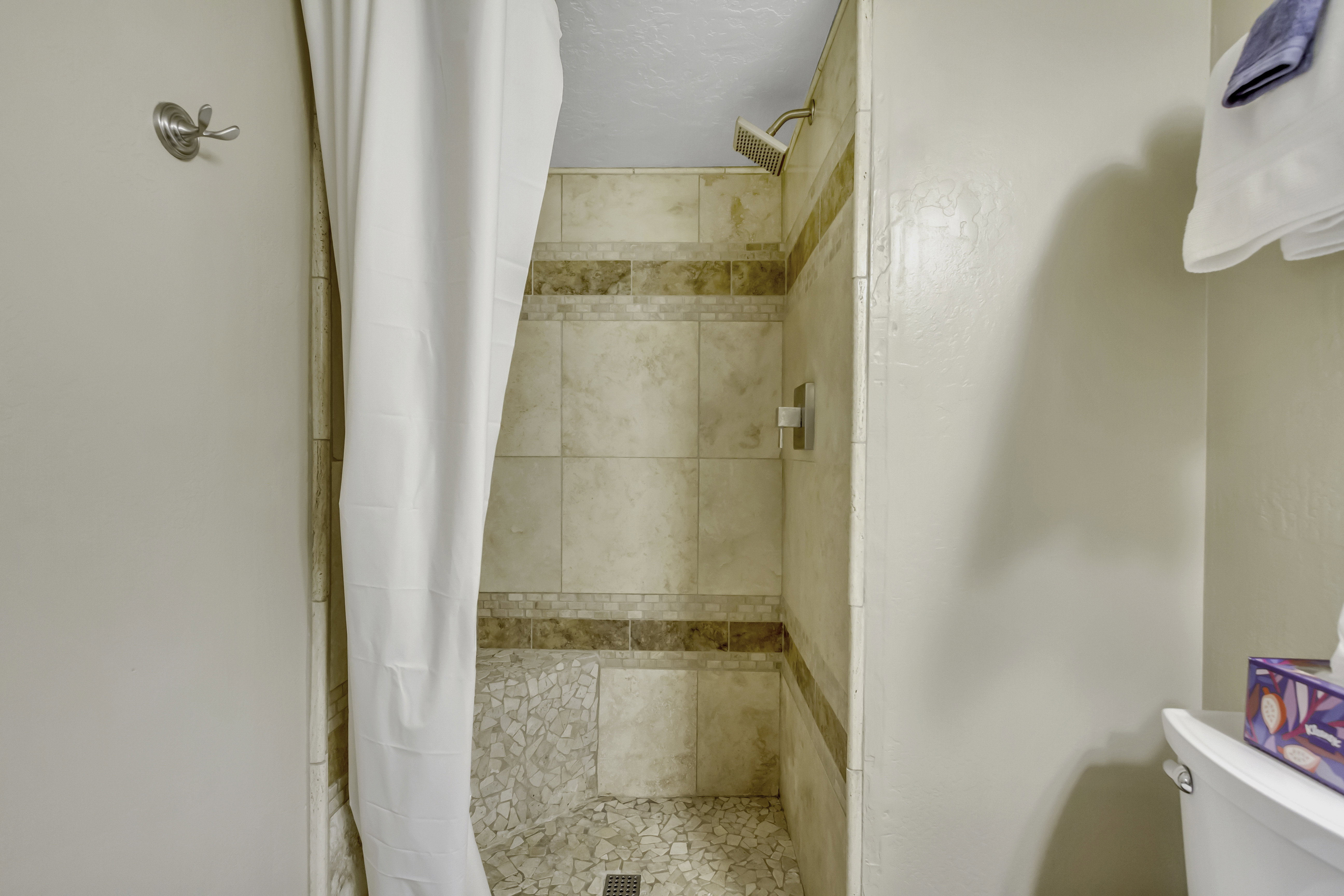 Full bathroom with a shower stall
