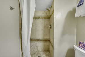 Full bathroom with a shower stall