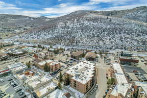Snowy aerial view featuring a mountain view