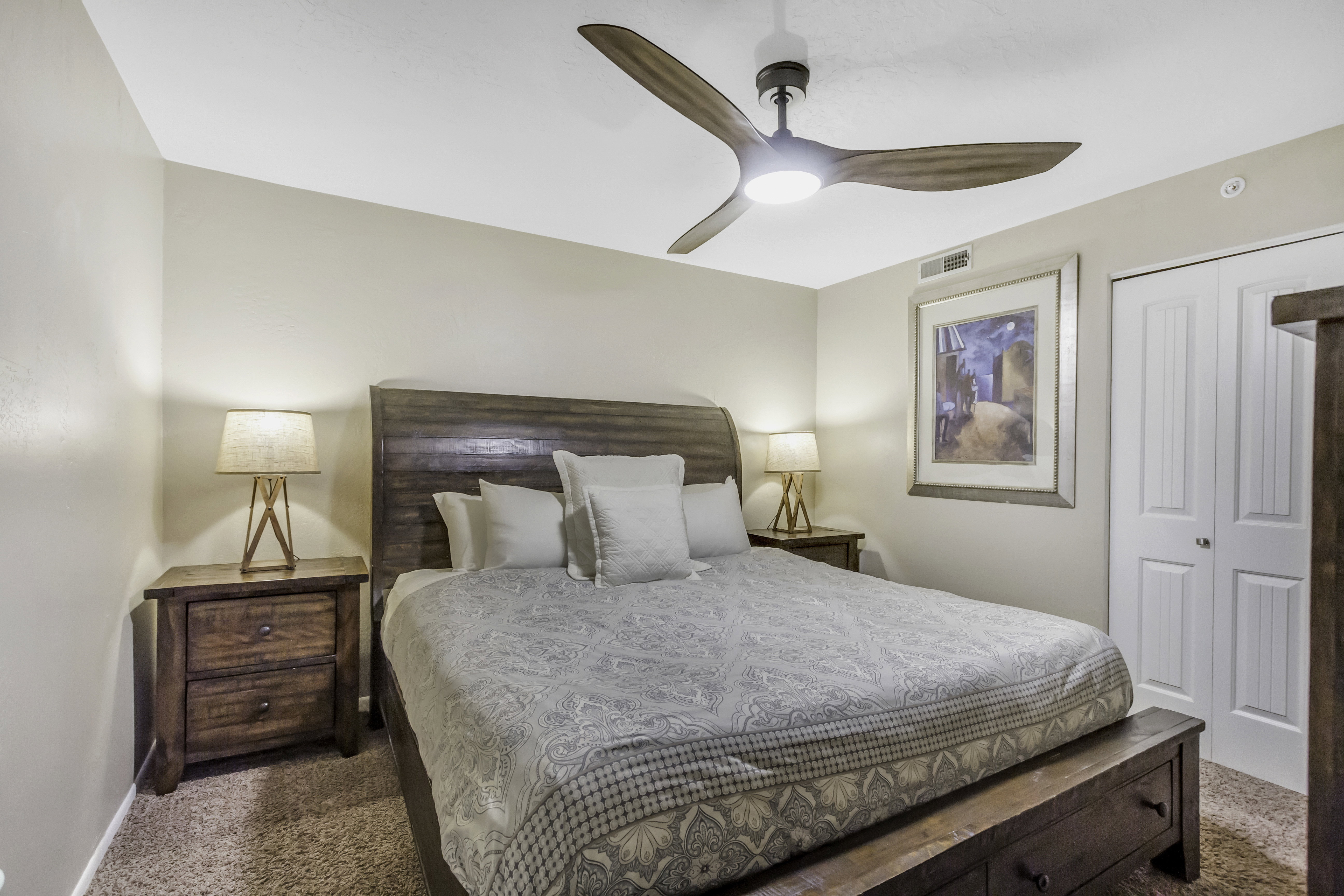 Bedroom with carpet flooring, a closet, and ceiling fan