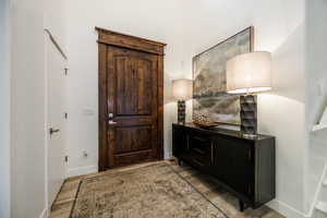 Entrance foyer with light wood finished floors and baseboards